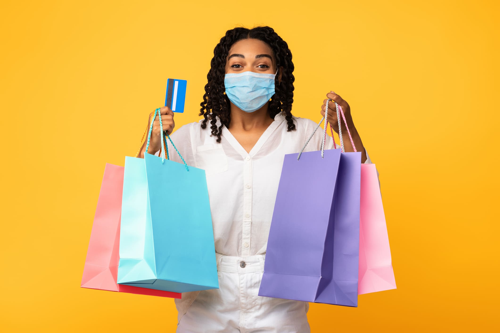 African Woman Shopping In Mask Holding Credit Card Shopping In Mask Holding Credit Card and Bags